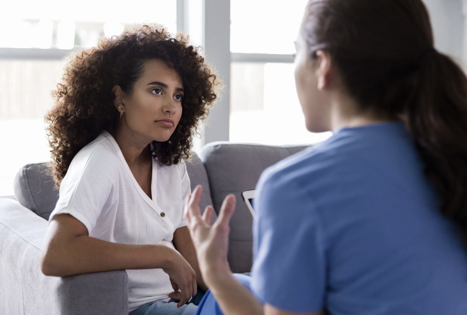 two people having a conversation, one is listening