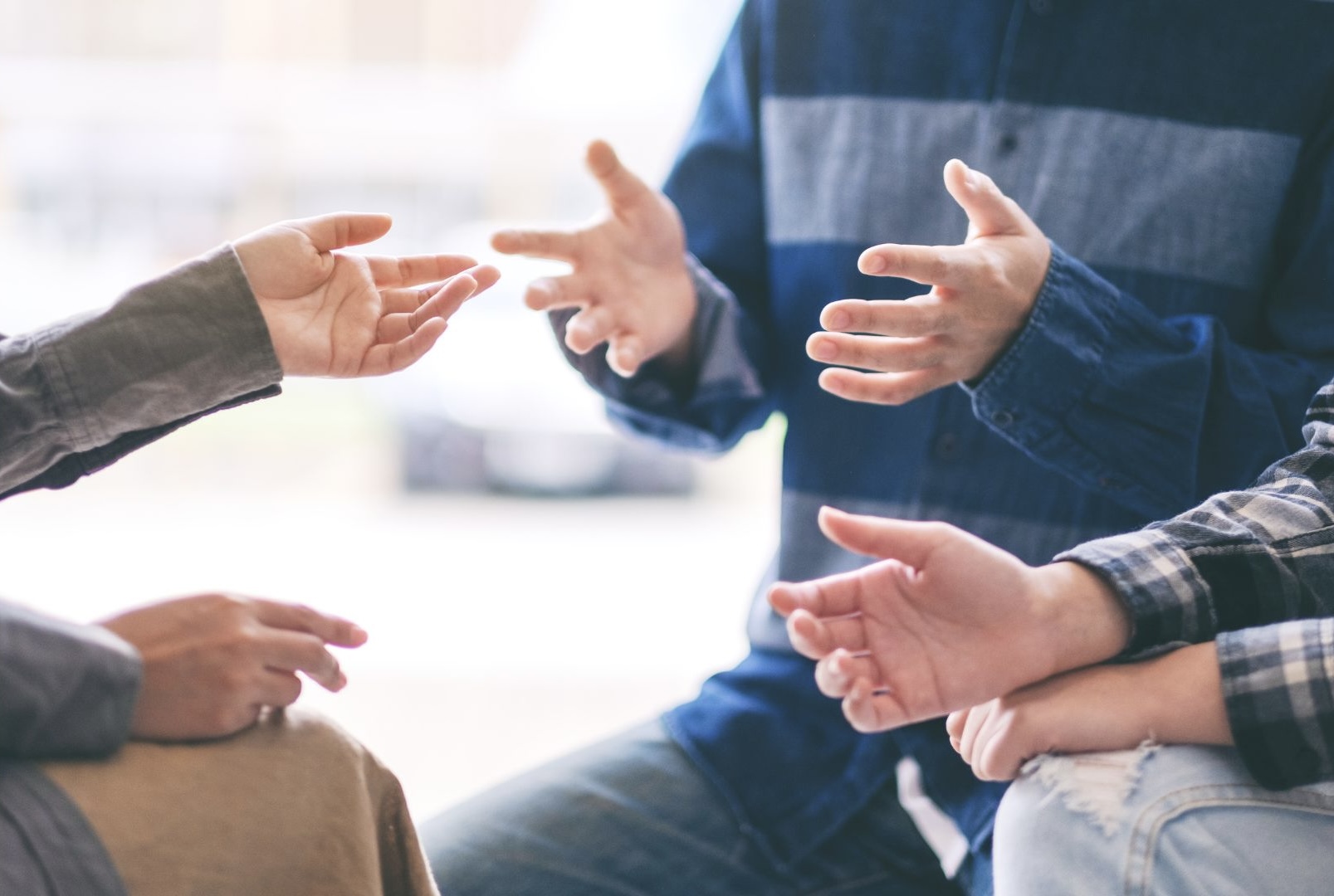 a group of people practicing sign language - contact A2Z interpreting