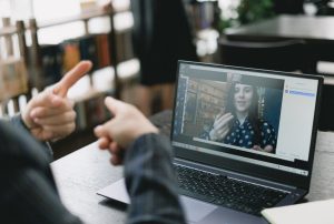 two people practicing their sign language skills over an online tutoring environment